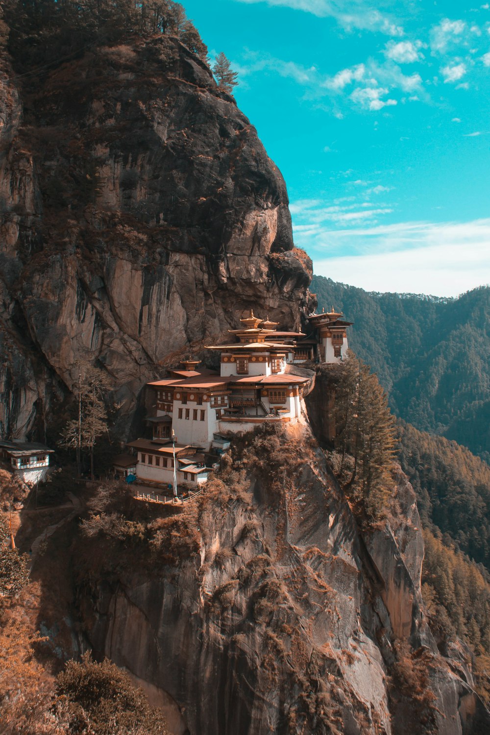 a cliff side with a building on top of it