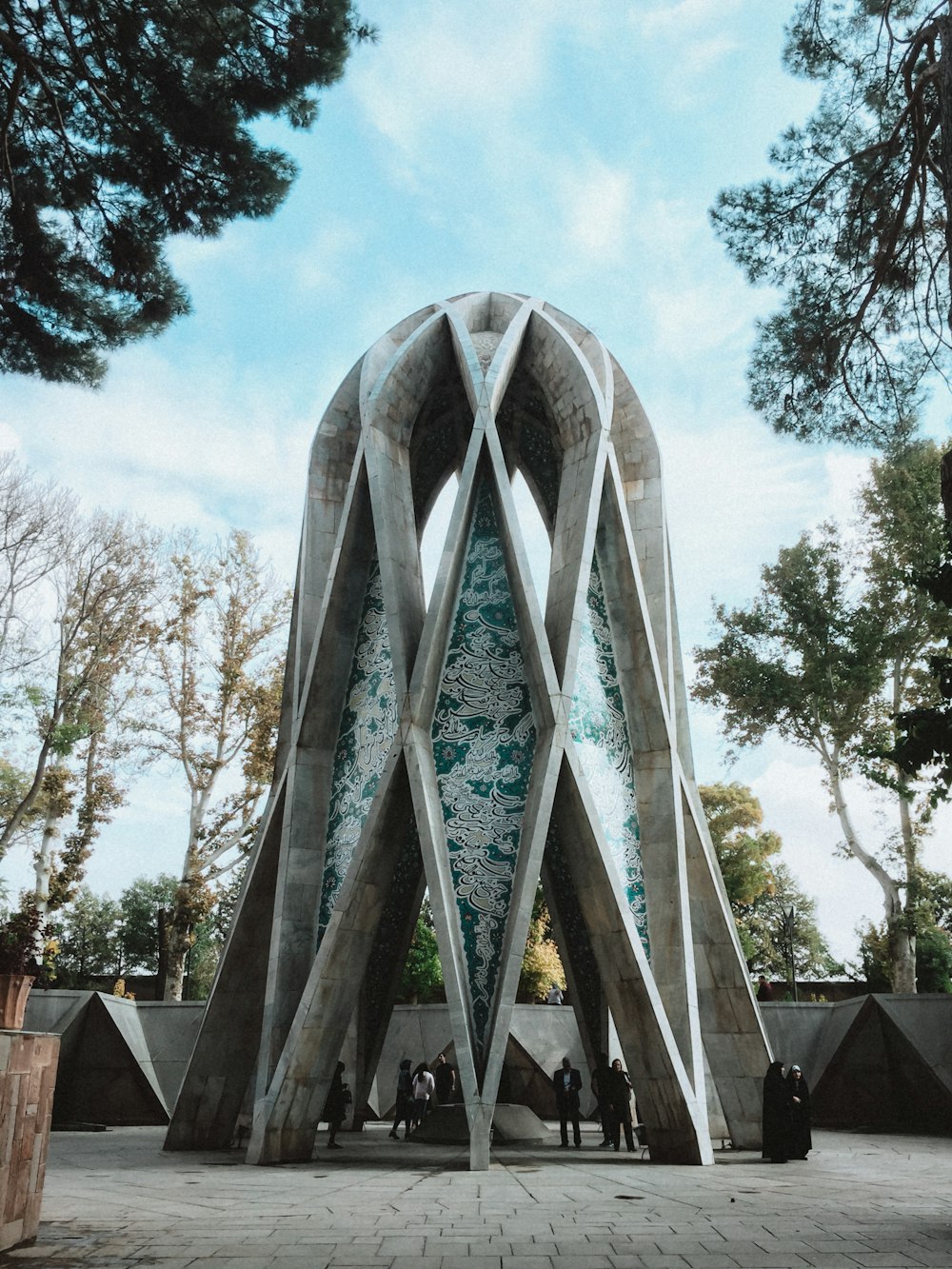 people inside concrete dome near trees during day