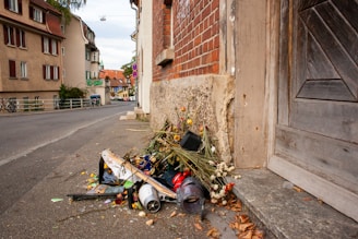 A neat pile of removed junk items ready for disposal outside a residential property.