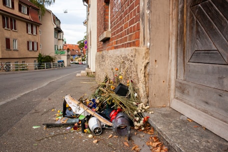A neat pile of removed junk items ready for disposal outside a residential property.