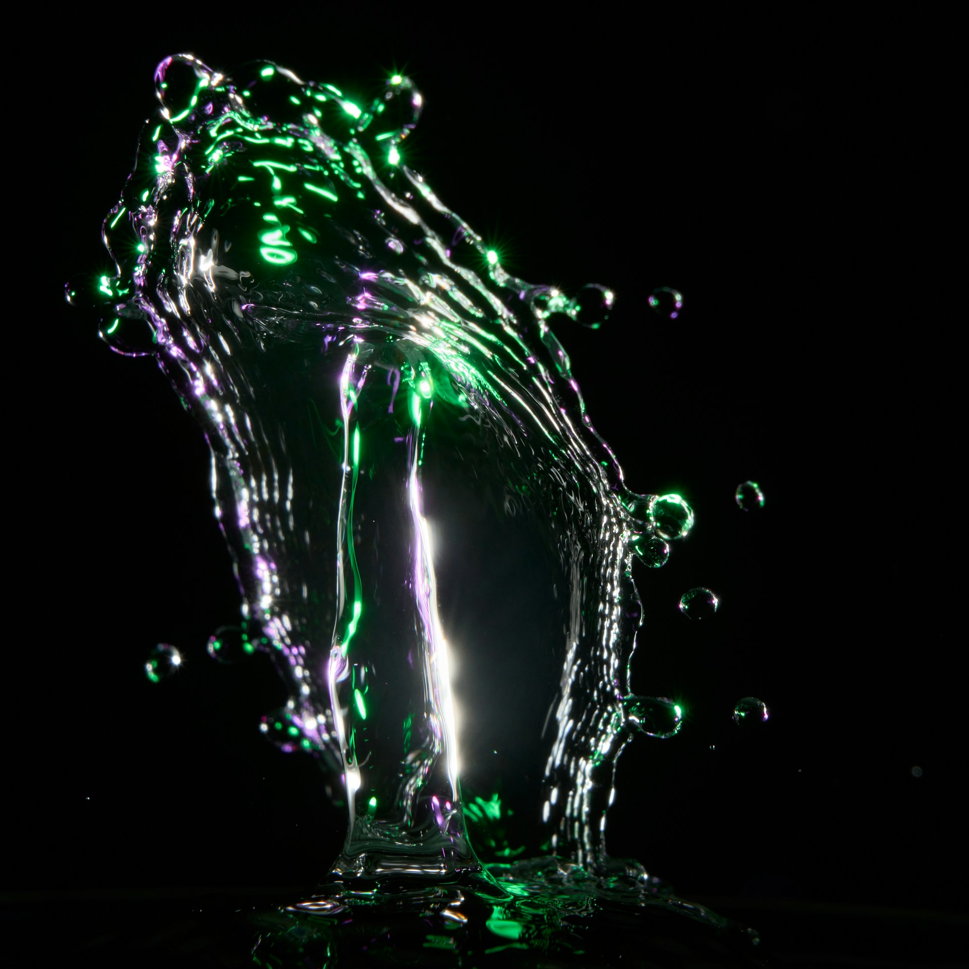 A dynamic frame from a video showing fluid motion graphics in black, silver, cyan, and purple tones.