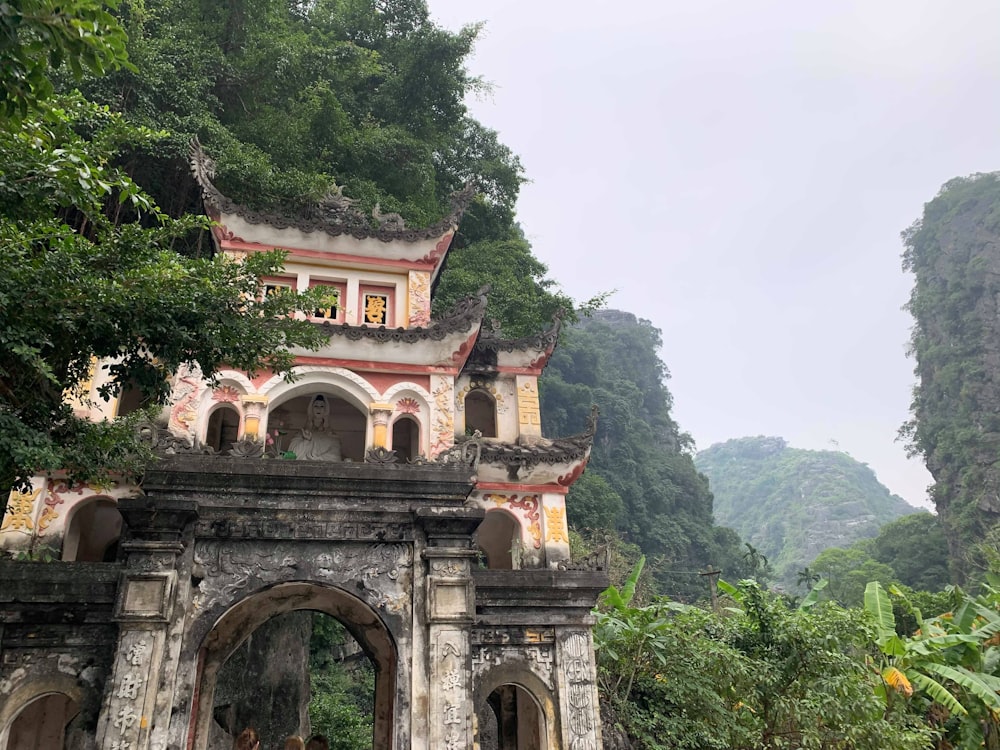 white and red temple near trees