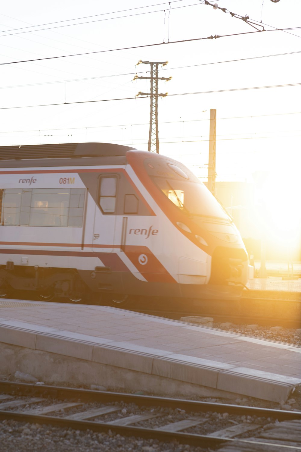 white and red train on train station