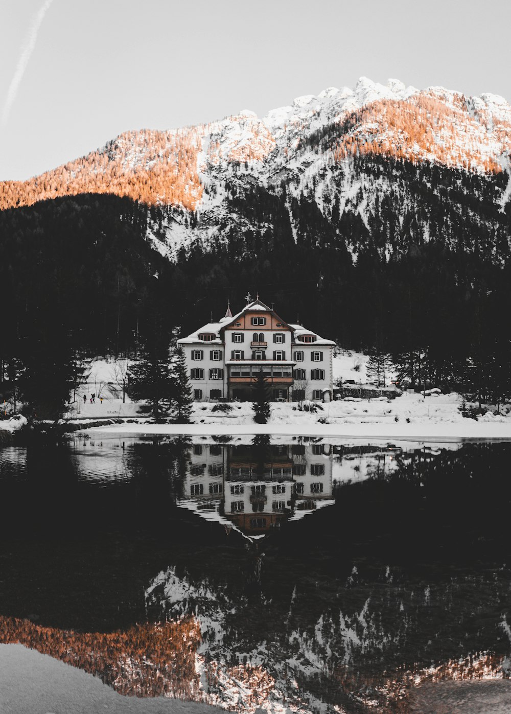 white and brown house near body of water