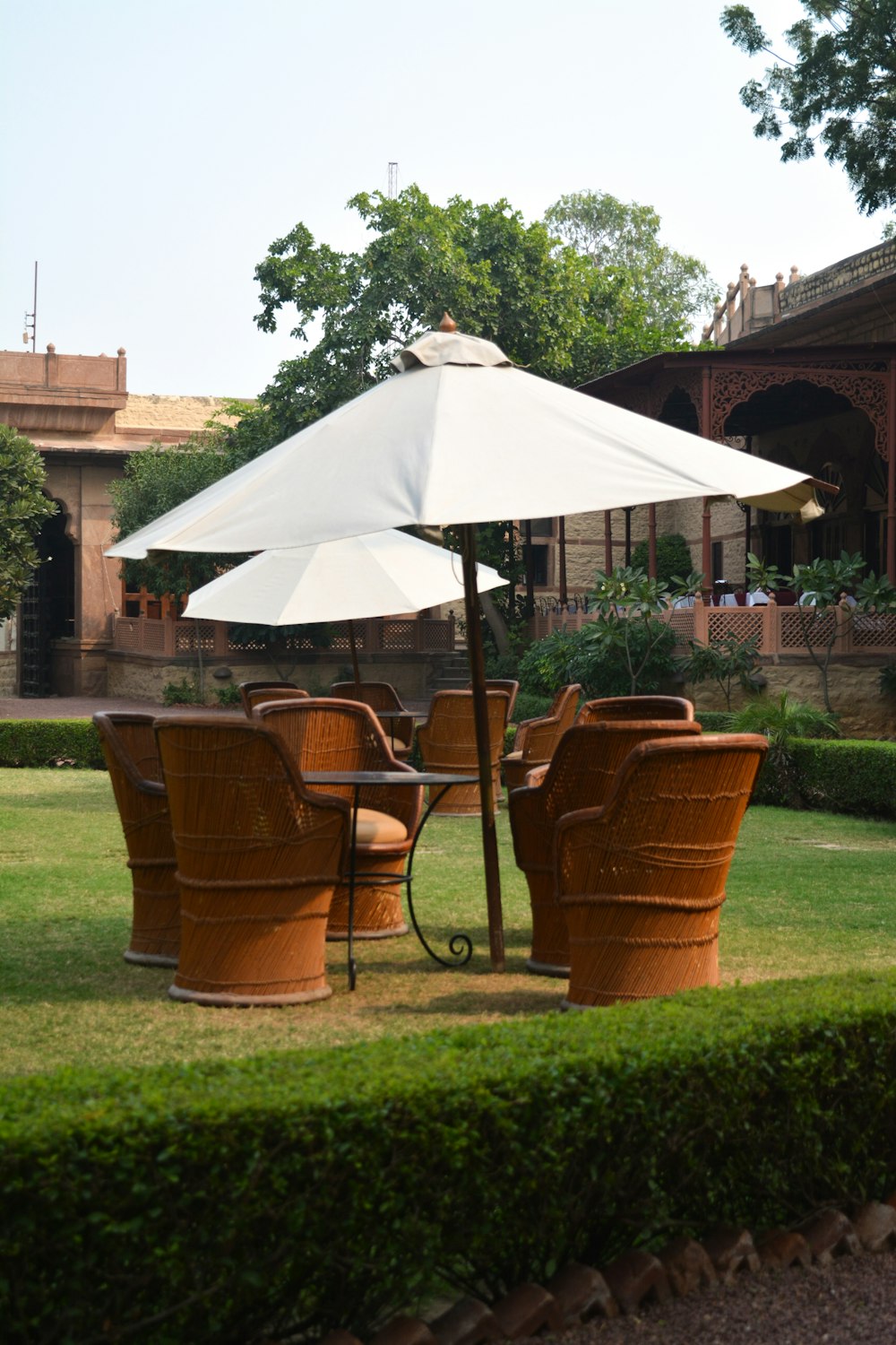 patio sets on grass near house during day