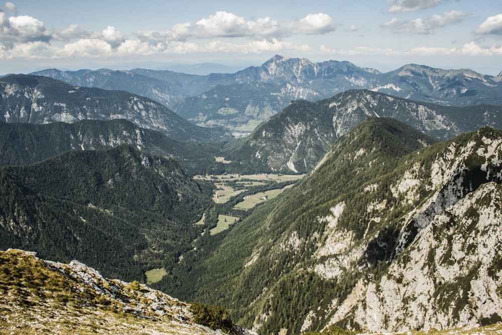 grass and rocky mountains during day