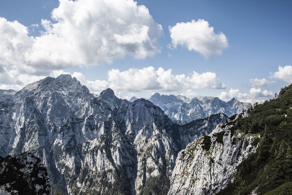 a view of a mountain range with clouds in the sky