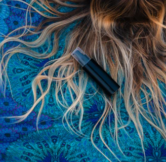 woman lying on blue floral textile