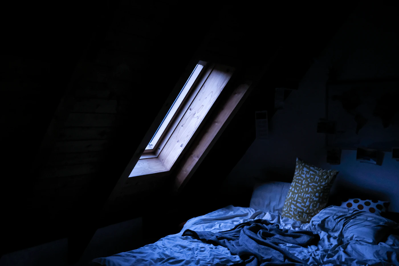 A bed near a window in soft daylight