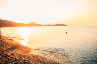 A tranquil beach scene captured during golden hour.