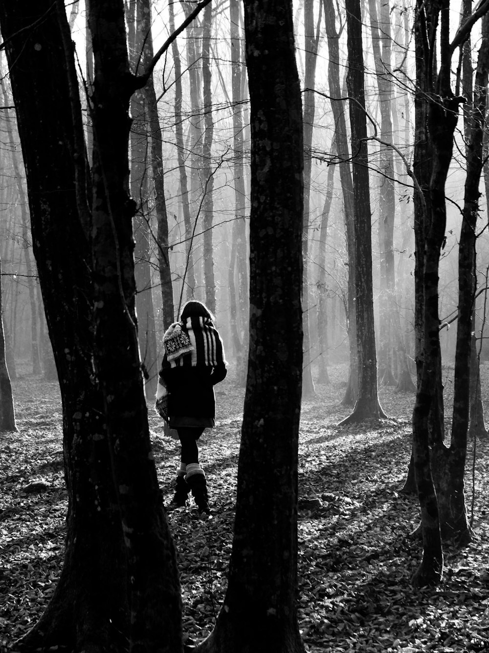 woman walking in the woods during day