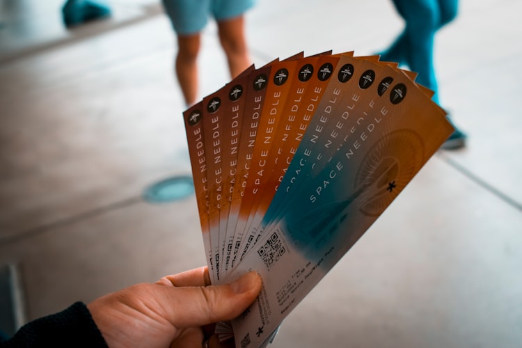 Someone holding a stack of tickets.