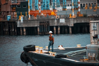 man standing on sailboat