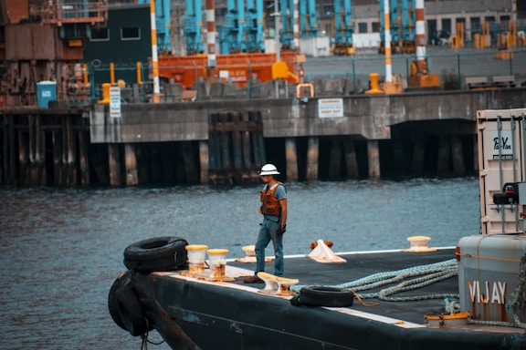 man standing on sailboat