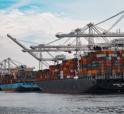 cargo ships docked at the pier during day