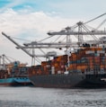 cargo ships docked at the pier during day