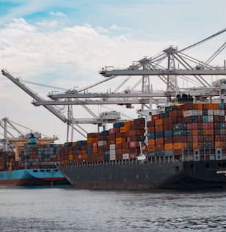 cargo ships docked at the pier during day