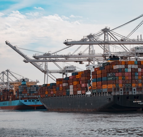 cargo ships docked at the pier during day