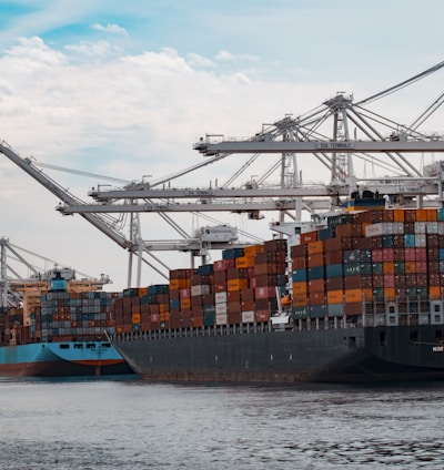 cargo ships docked at the pier during day