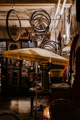 A cozy French café scene with a vintage bicycle leaning against a rustic wall adorned with French flags.