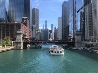 people riding boat at the city during day