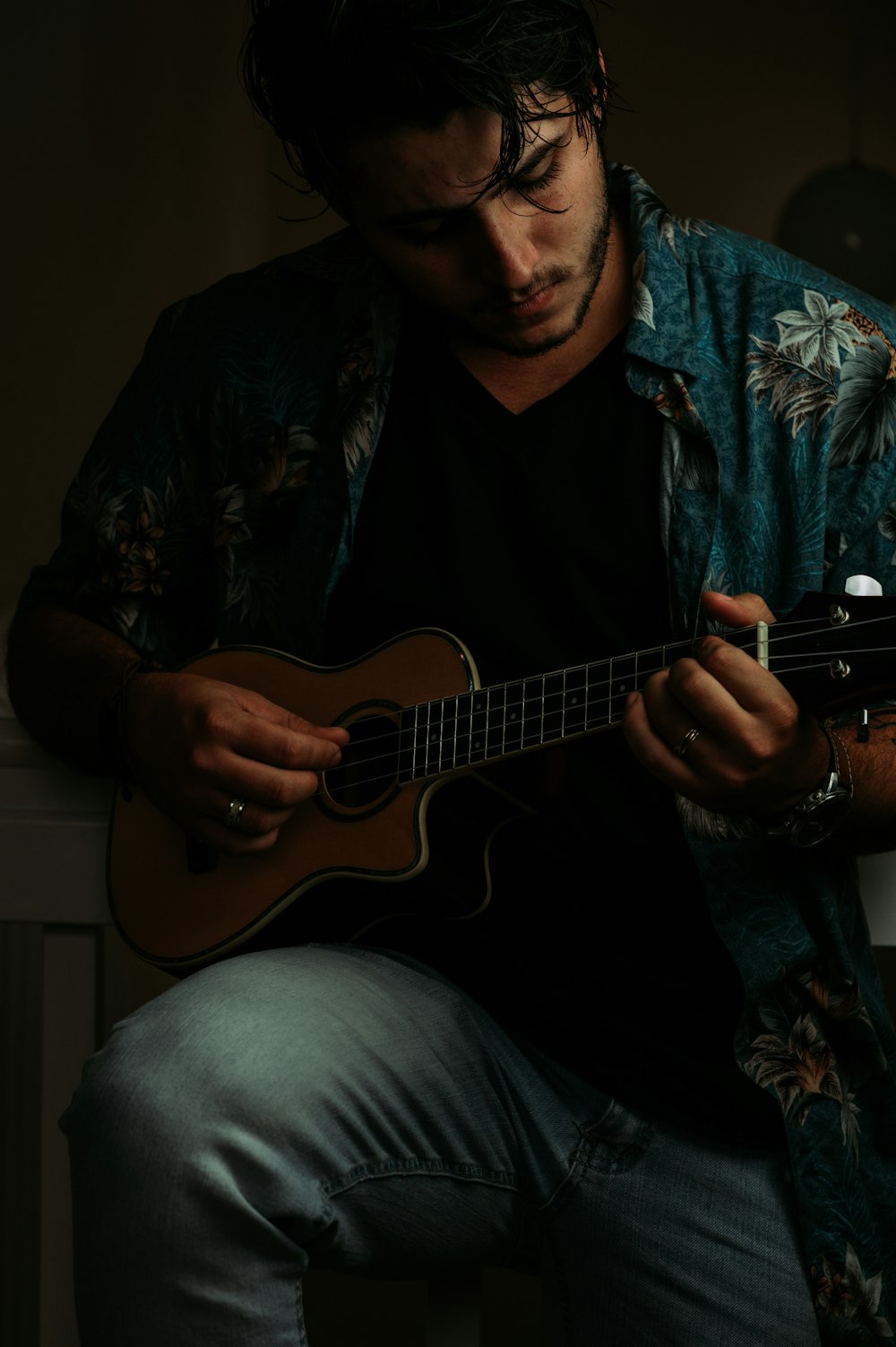 man playing ukulele