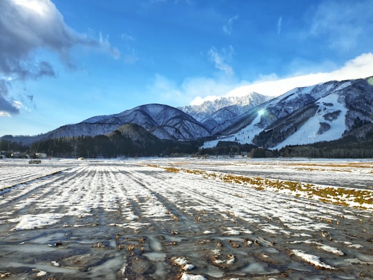 snowfield and glacier mountains during day in Iimori Japan