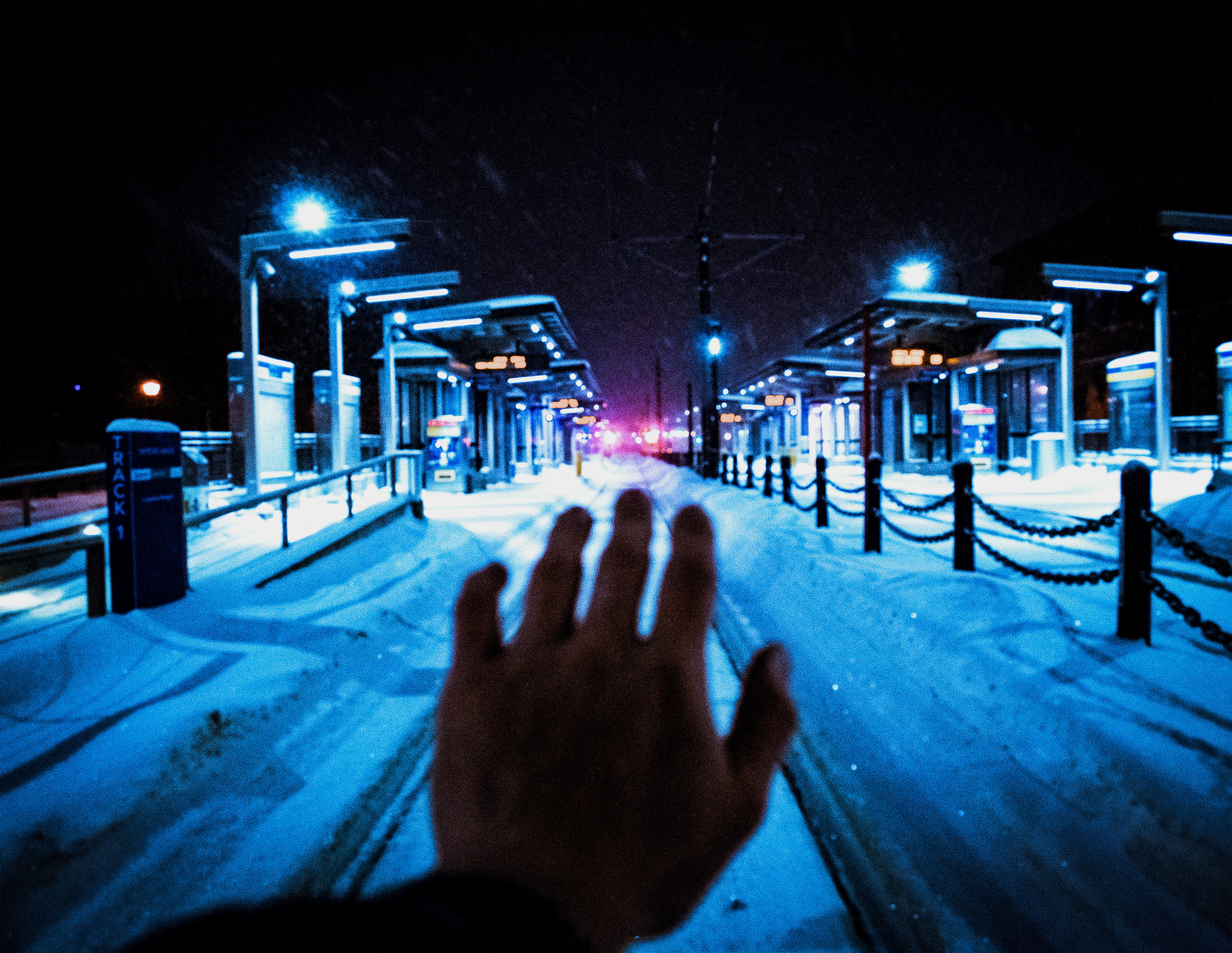 road and street covered with snow with lighted street lights during night time