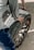 person holding vehicle wheel and rim