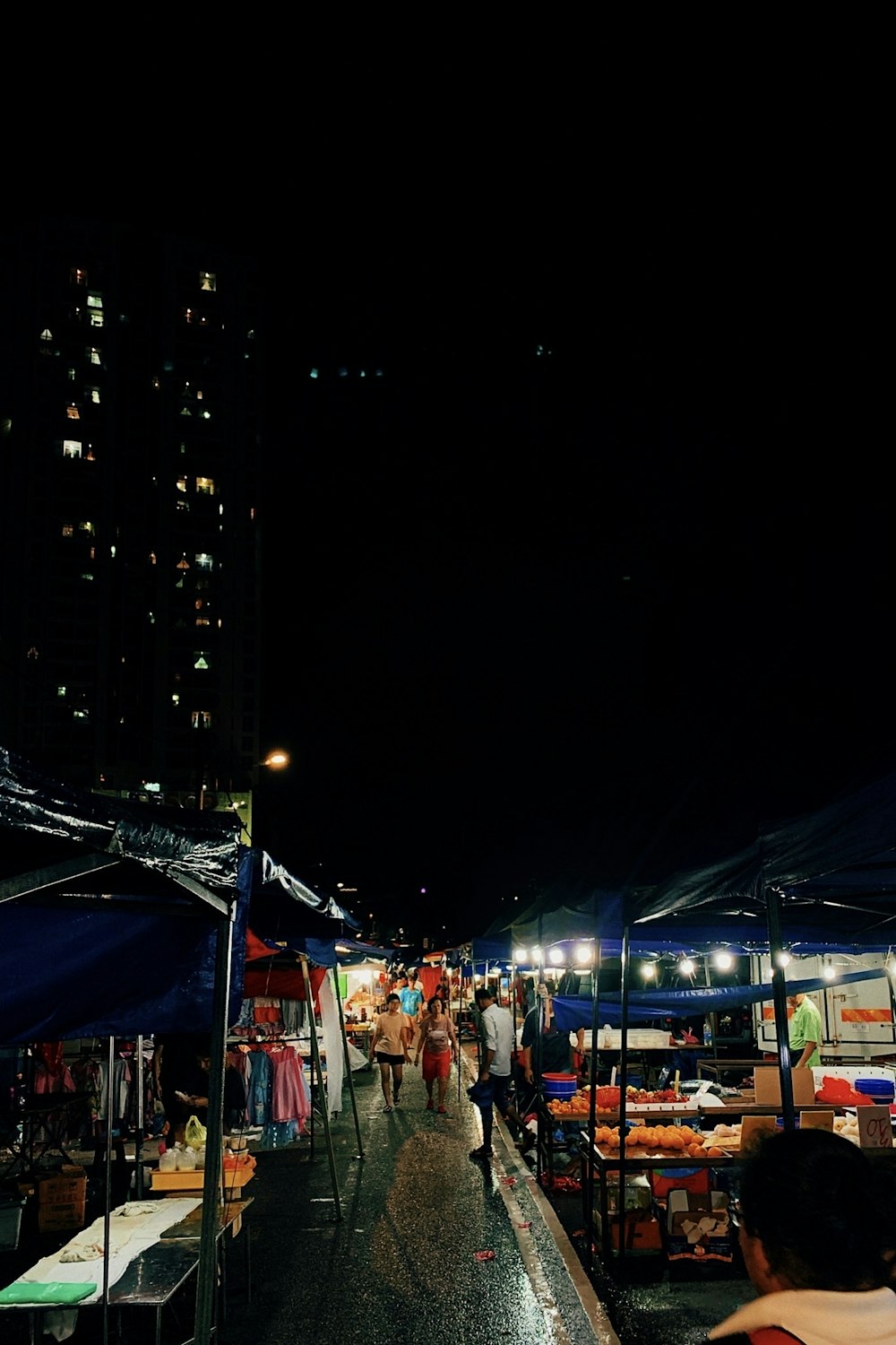 people and canopy stores during night