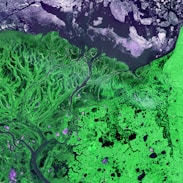 an aerial view of a river and land