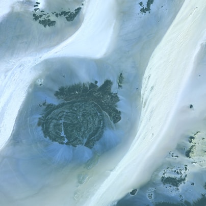an aerial view of a snow covered mountain