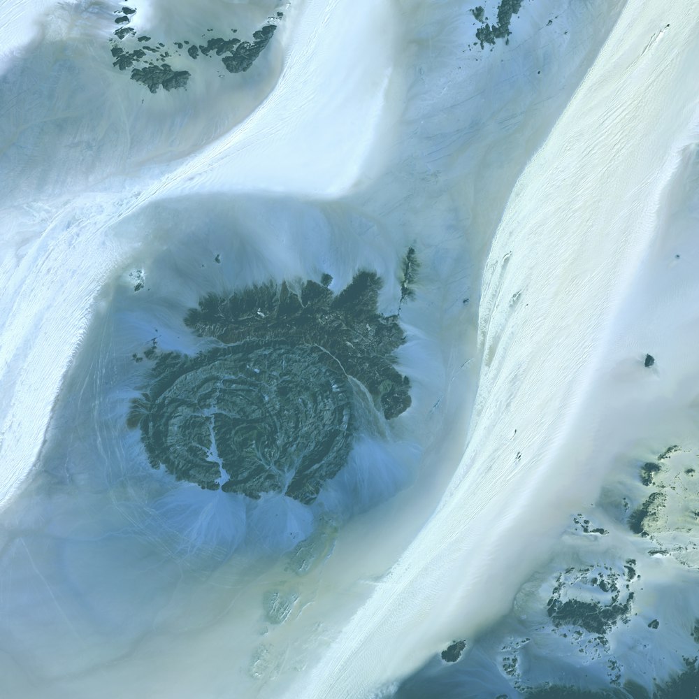 an aerial view of a snow covered mountain