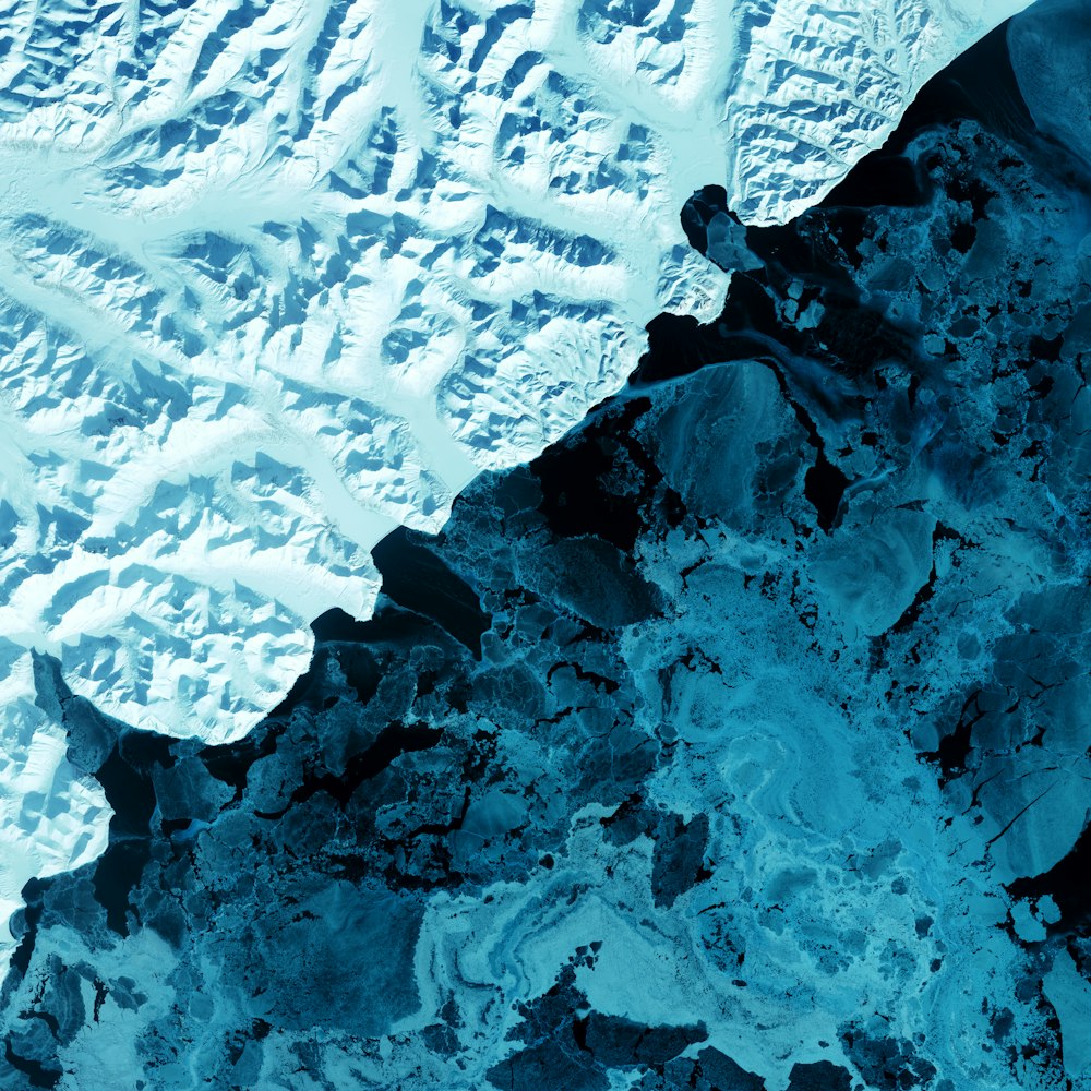 an aerial view of a snow covered mountain