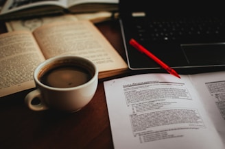 cup of coffee beside open book