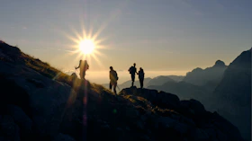 four person on mountain during daytime