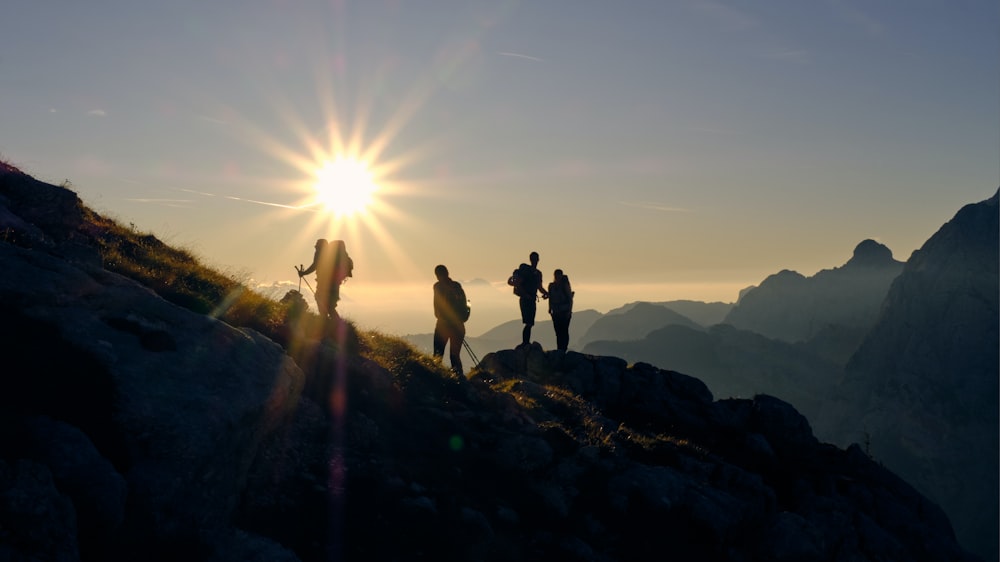 four person on mountain during daytime