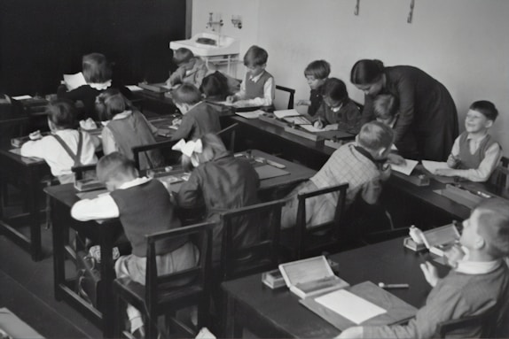 A teacher assisting a student with their work, showcasing a supportive and interactive learning environment.