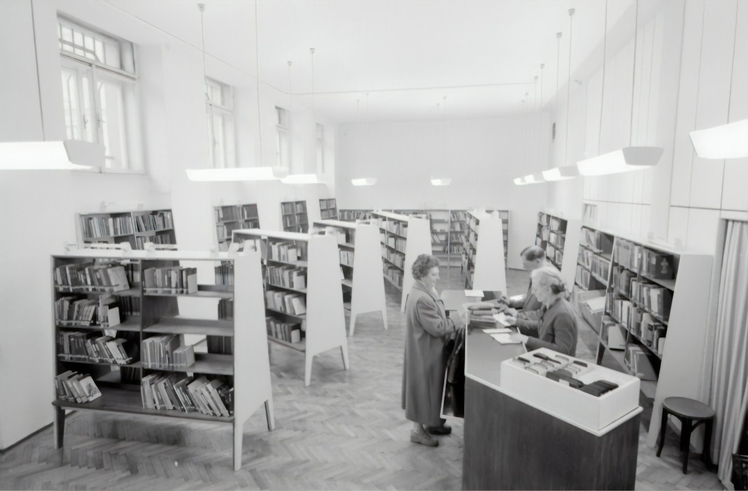 grayscale photography of people inside book store, Adult Education Center Vienna, 1959