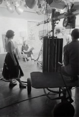 grayscale photography of people inside studio