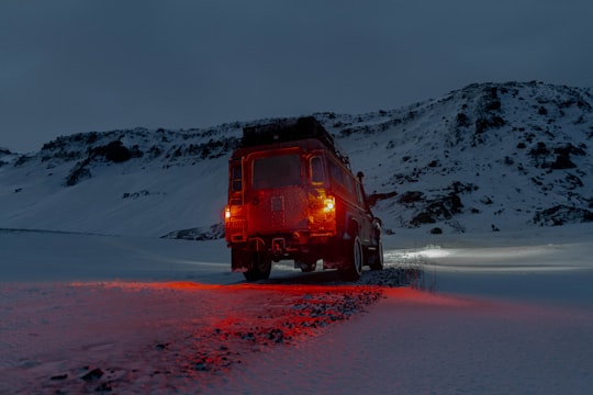 brown SUV on snow near mountain hill in Krýsuvík Iceland