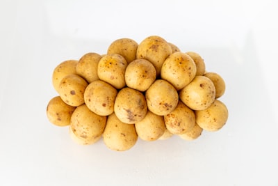 ripe lanzones fruits potato teams background