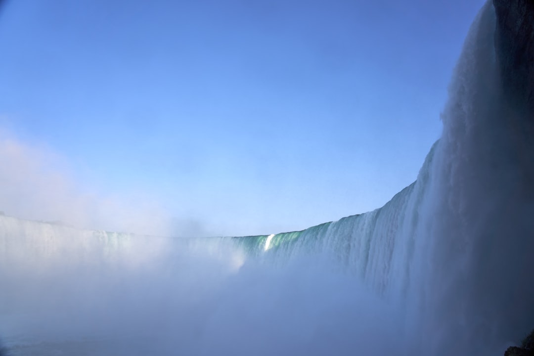 waterfalls under blue and white sky