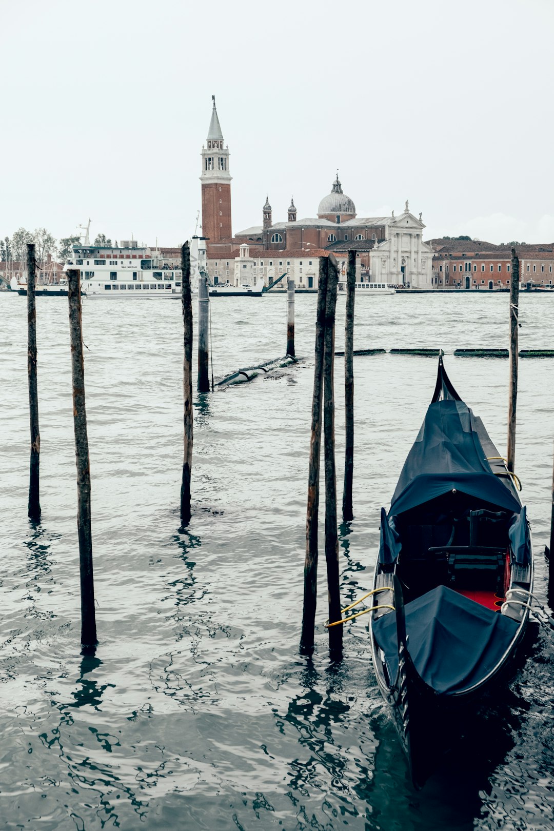 black boat on body of water during daytime