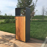 A sleek trash can pull-out neatly tucked under a kitchen counter with a wooden finish