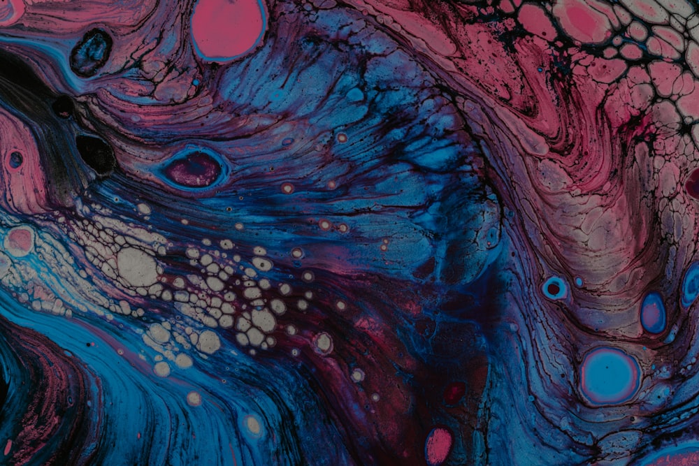 a close up of a blue and pink painting