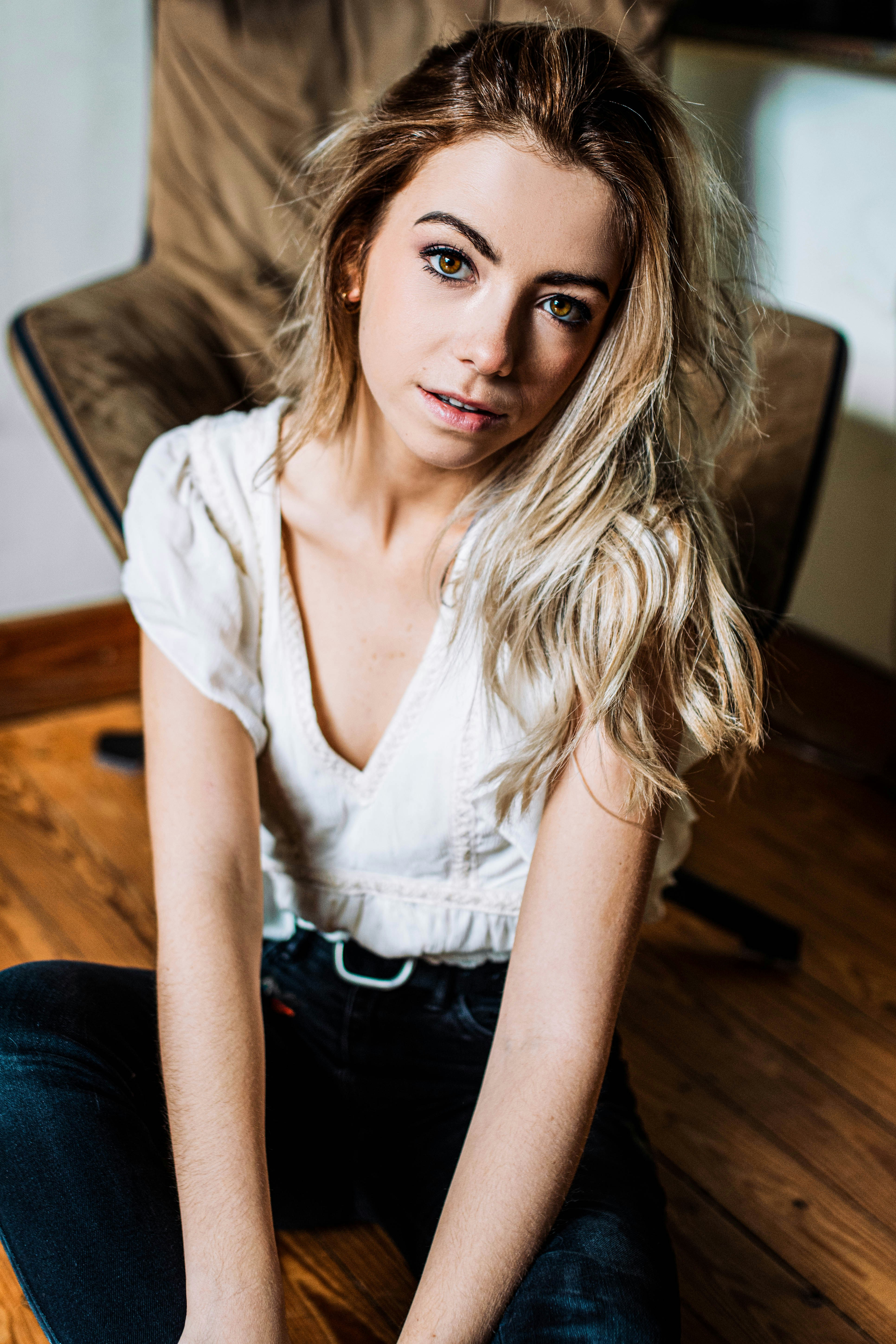 woman smiling and sitting while looking at the camera