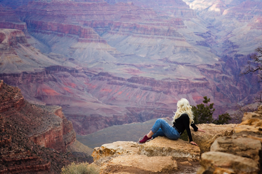 woman sitting on near cliff