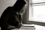 An inspiring image of a person reading a book in a serene environment.
