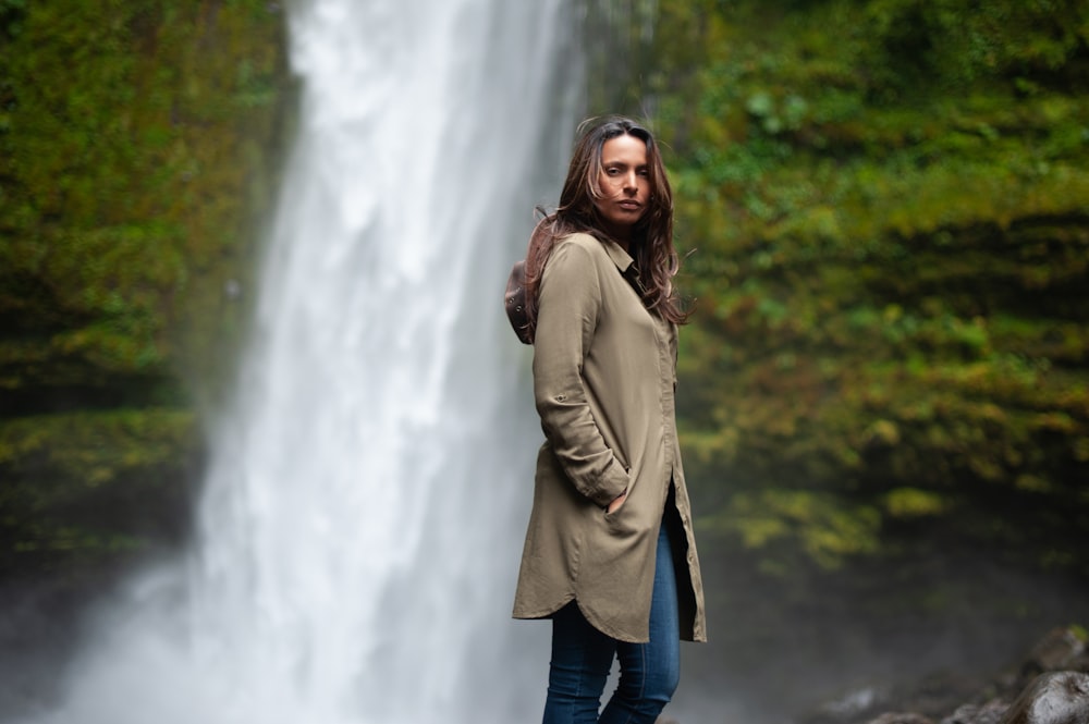 woman standing near waterfalls